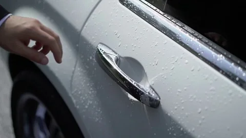 Man opens the door of white car Stock Footage 79649719