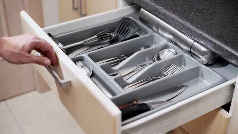 Man opens a drawer with a set of cutlery in the kitchen. Stock Footage 145434530