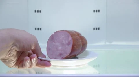 The man opens the empty fridge and puts back the sausage, close up Stock Footage