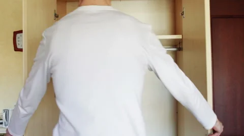 Man opens an empty wardrobe in which only empty hangers Stock Footage 49113820