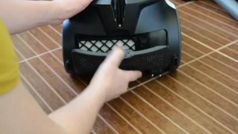 A man opens a filter from a vacuum cleaner Stock Footage 141378263