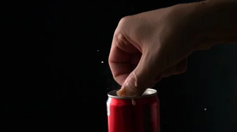 Man opens foamy cola can. Slow motion shot against black background Stock Footage 61203132