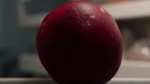 Man opens a fridge and grabs a peach at night, close-up Stock Footage 250823232