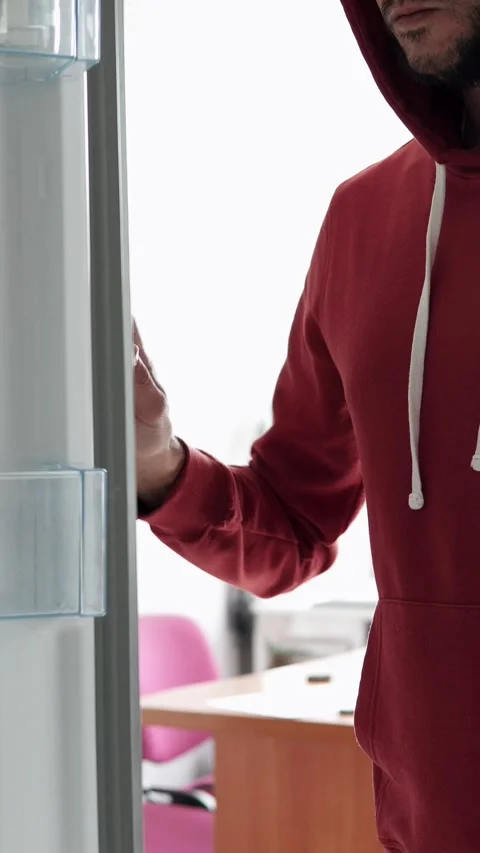 Man opens fridge and grabs alcohol bottle in quiet kitchen. Stock Footage 317687668
