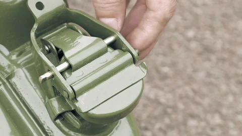 Man opens gas petrol or diesel jerry can with fuel Stock Footage 69999024