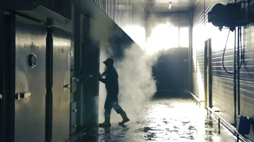 The man opens a heavy iron door, a smoking chamber for meat Stock Footage 85601116