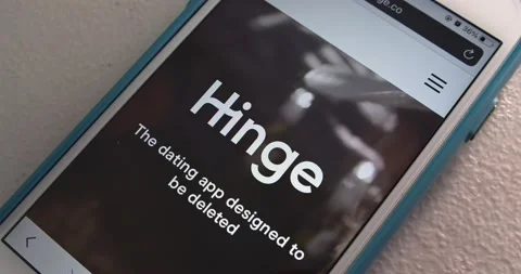 Man opens Hinge app on his iPhone and watches introduction Stock Footage 156639274