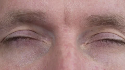 The man opens his eyes, looking into the camera. Stock Footage 274837403