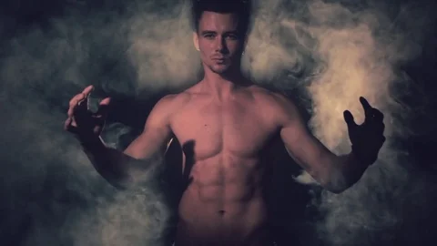 Man opens his hands in the smoke. Stock Footage 80793994