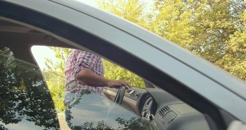 The man opens the hood of the broken smoking car that overheated. with the Stock Footage 134166355