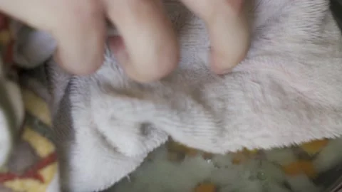 A man opens a hot skillet, inside which carrots and onions are being sauted Video stock 232432151