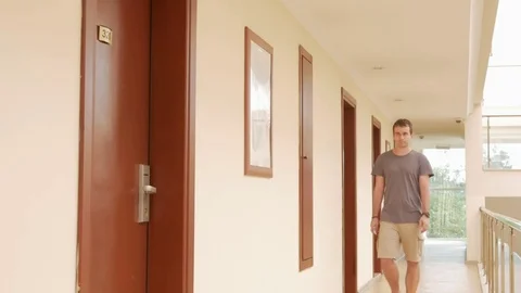 A man opens a hotel room with a card key. Stock Footage 76477757