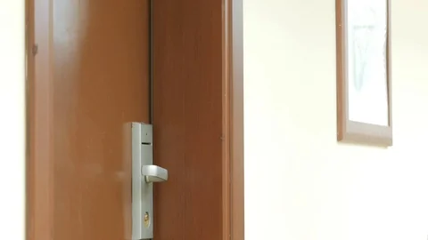 A man opens a hotel room with a card key. Stock Footage 76478148
