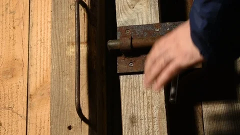 Man opens an iron bolt and goes out into the darkness Stock Footage 122009902