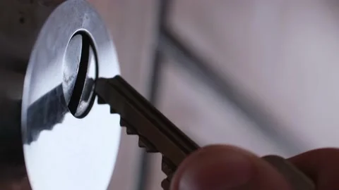 A man opens an iron lock with a key Stock Footage 177507682