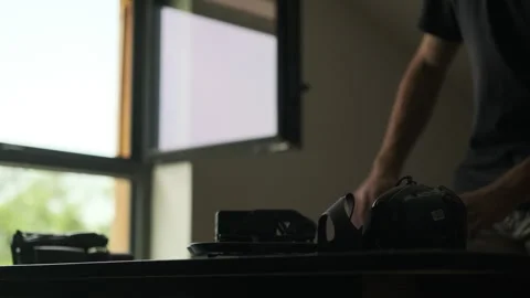 Man opens the laptop for editing. Silhouette. Filmmaker Edits. Drones next to it Stock Footage 243425273