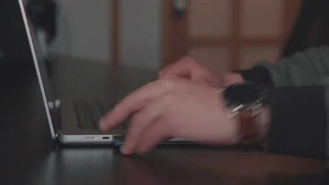 Man opens laptop, inserts reduction with cable into usb c port, write on the key Stock Footage 186951295
