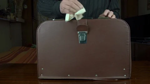 Man opens leather suitcase and wipes antique sewing machine Stock Footage 127150363