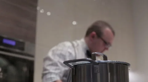 The man opens the lid on the pan Video stock 62745169