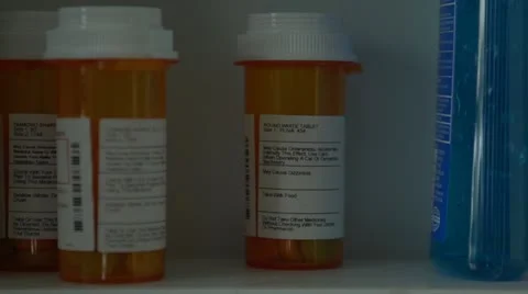 Man opens medicine cabinet, then grabs prescription medicine Stock Footage