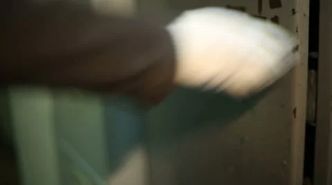 The man opens the metal closet and pushes a box of tools Stock Footage 59595813