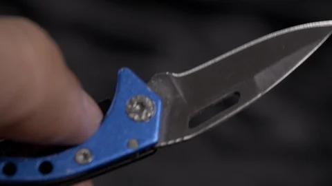Man opens a mini camping knife 4k. Stock Footage 96280237