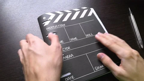 The man opens the notebook, and begins to slowly flip through all the pages Stock Footage 160555682