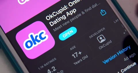 Man opens OkCupid app (often abbreviated as OKC) from App Store on iPhone Stock Footage 149426378