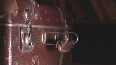 The man opens an old battered brown suitcase. Stock Footage 137738371