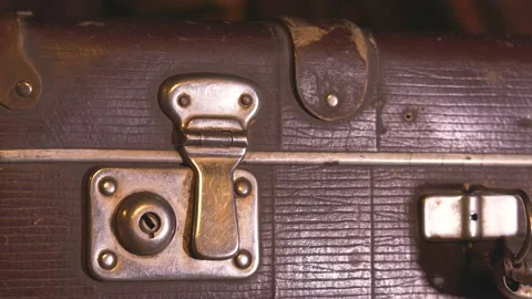 The man opens an old battered brown suitcase. Stock Footage 137738393
