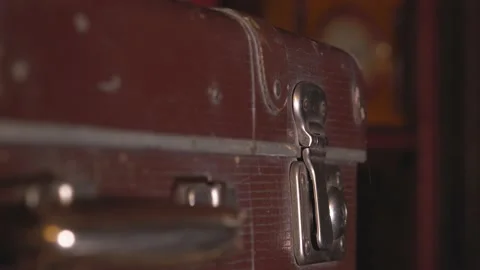 The man opens an old battered brown suitcase. Stock Footage 137738405