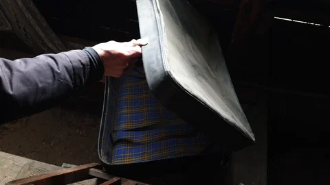 The Man opens the old suitcase in the dust. Left suitcase. Stock Footage 106003287