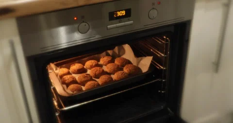 A man opens the oven and takes out ready-made fish cakes 스톡 동영상 243776222