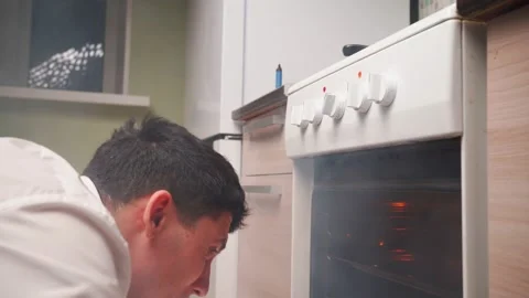 Man Opens an Oven Full Smoke in Kitchen. Bachelor Ruined Dinner with Burnt Food Stock-Footage 170504121