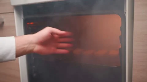 Man Opens an Oven Full Smoke in Kitchen. Bachelor Ruined Dinner with Burnt Food Stock-Footage 170853153