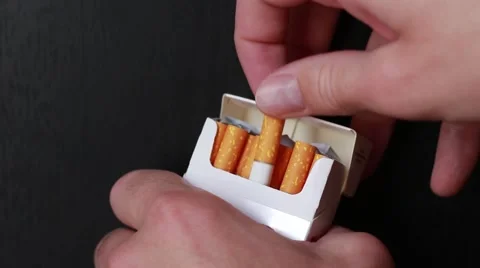 Man opens a pack and takes a cigarette Stock Footage 65372221