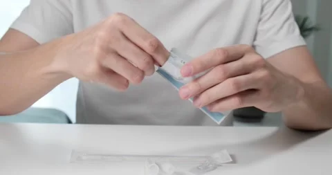 Man opens package with covid-19 self test cassette. Video stock 155074431