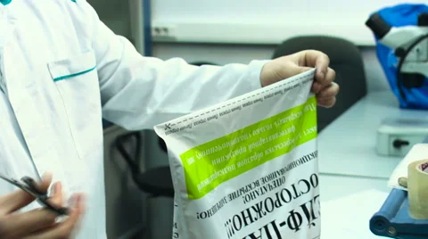 Man opens the package with ginger for examination food control Stock Footage 59848742
