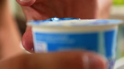 Man Opens Packing with Yoghurt for Breakfast. Closeup. 스톡 동영상 41596284