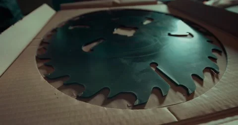 A man opens a paper package that contains a circular saw. Manufacturing equipmen 스톡 동영상 158642125