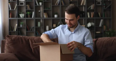 Man opens parcel box feels satisfied by delivered goods 스톡 동영상 155918385