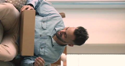 Man opens parcel box feels satisfied with received goods Stock Footage 252475850