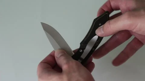 Man opens penknife Stock Footage 66755602
