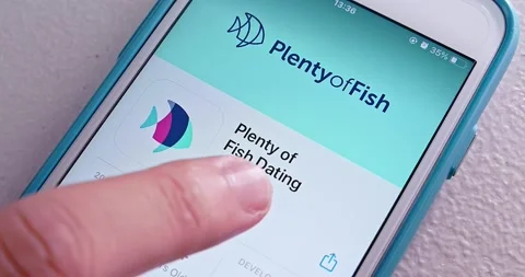 Man opens Plenty of Fish app from App Store on iPhone Stock Footage 156639255