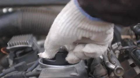 The man opens the plug of the filler neck of the car.The hand of a man in a w Stock Footage 165127387