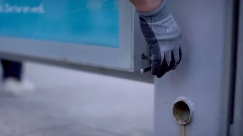 Man opens up a poster frame the city Stock Footage 75444958