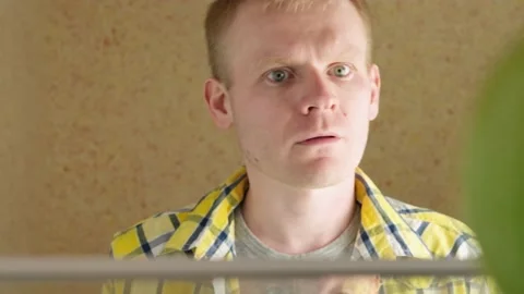 Man opens the refrigerator and looks inside Stock Footage 152298229
