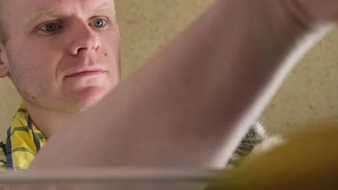 Man opens the refrigerator and looks inside Stock Footage 152298552