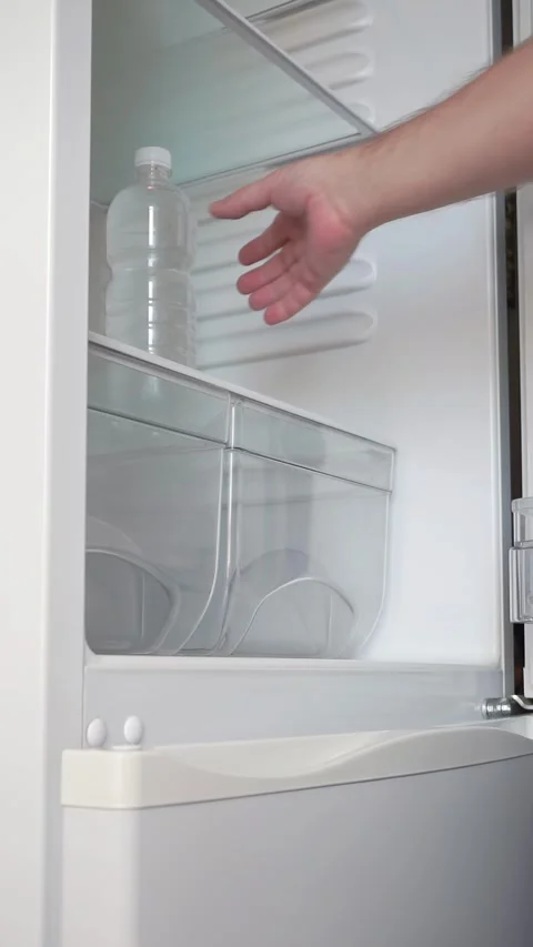 Man opens the refrigerator and takes out a bottle of water Stock Footage 281940119
