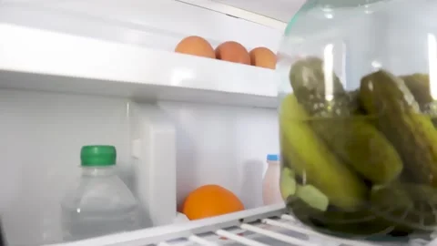 A man opens the refrigerator door and takes food Stock Footage 131133035